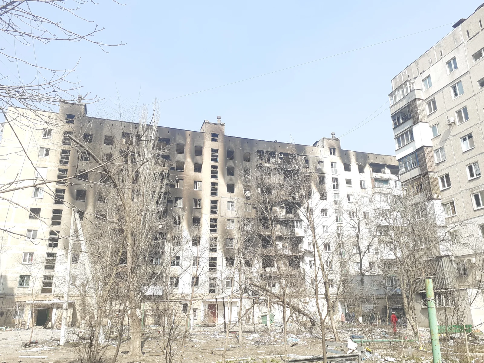 Edificio de viviendas con fachadas quemadas, ventanas rotas y escombros en la calle Mitropolitska de Mariúpol, fotografiado el 23 de marzo de 2022.